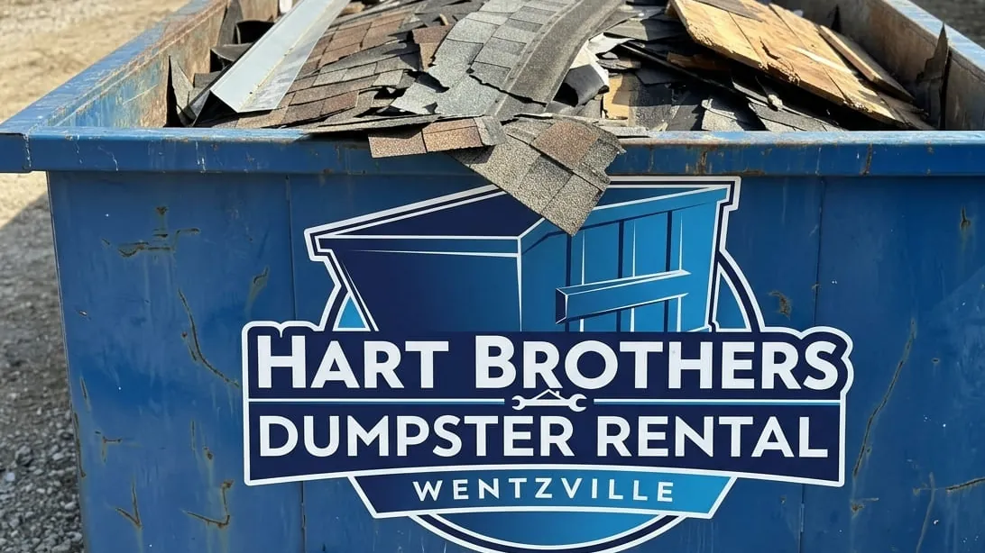 Storm and hail damage cleanup in Wentzville, Missouri — container taking roof, fence and siding debris
